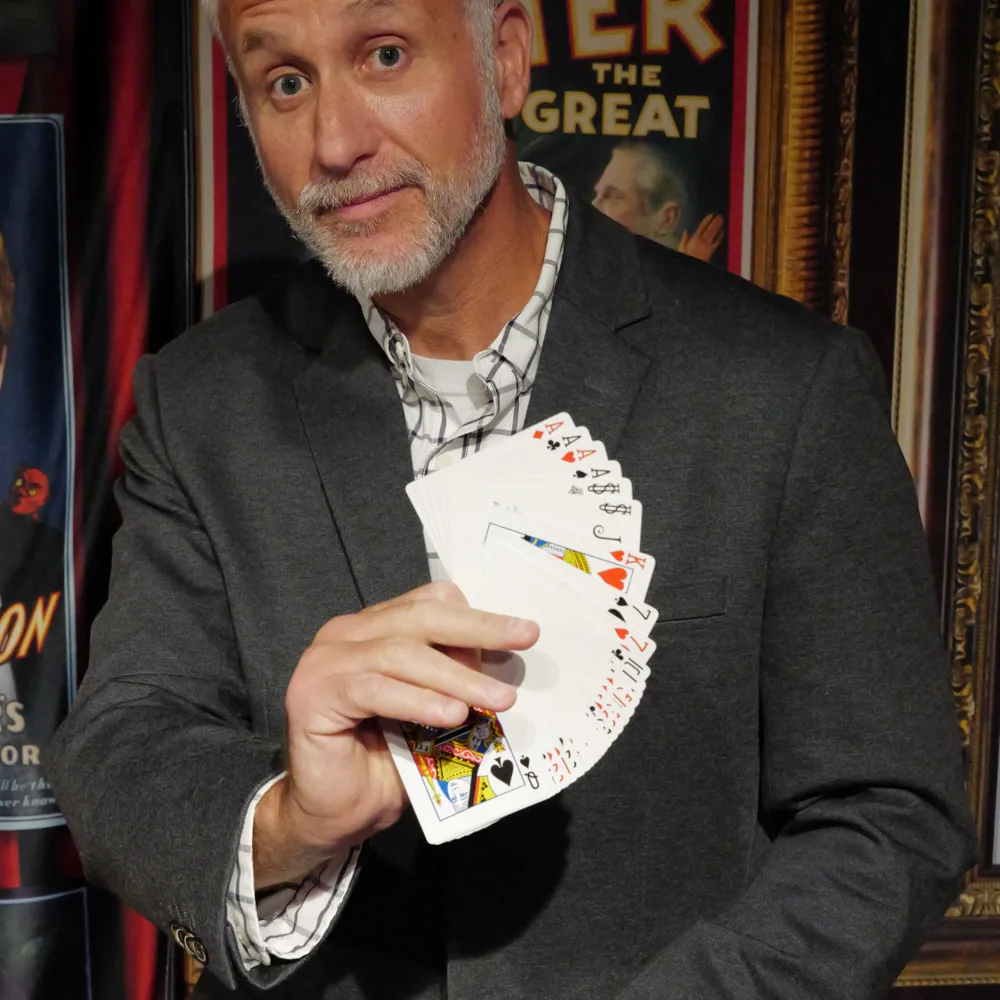 Mike Stringer fanning a deck of cards between his hands